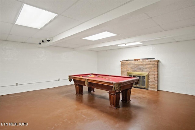 game room featuring a drop ceiling, pool table, and a fireplace