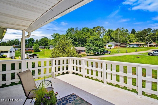 balcony with a water view and a porch