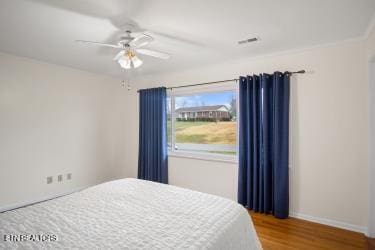 bedroom with ceiling fan and wood-type flooring