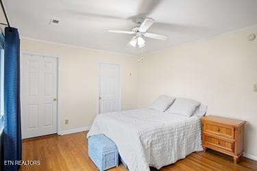 bedroom with ceiling fan and hardwood / wood-style flooring