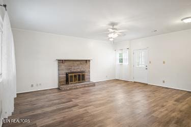 unfurnished living room featuring ceiling fan and dark hardwood / wood-style floors