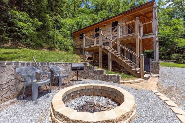 view of patio / terrace featuring a wooden deck and an outdoor fire pit