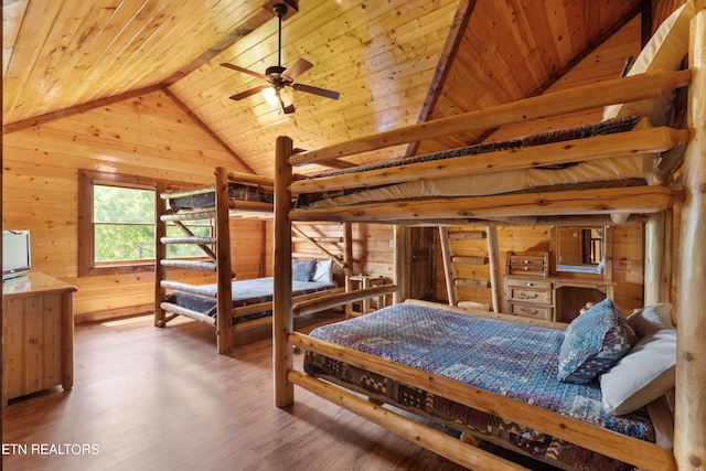 bedroom featuring wood ceiling, ceiling fan, hardwood / wood-style flooring, vaulted ceiling with beams, and wood walls