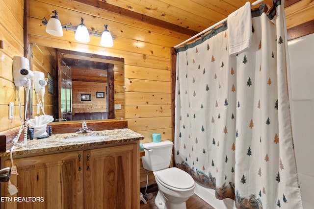 bathroom featuring wood walls, vanity, wood ceiling, and toilet