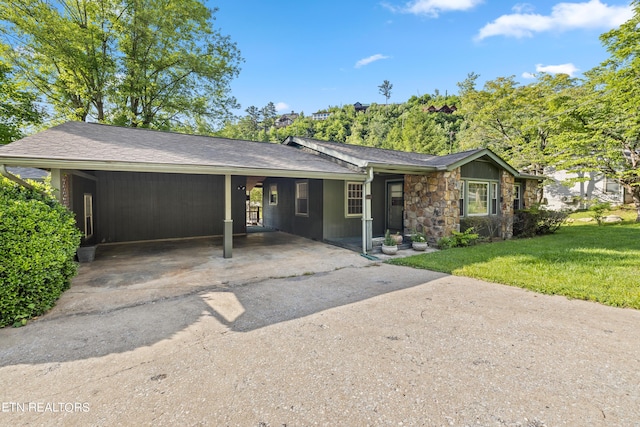 single story home with a front lawn and a carport