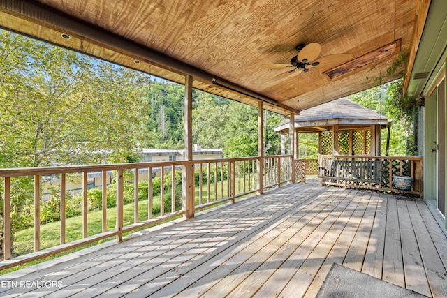 wooden deck with a gazebo and ceiling fan