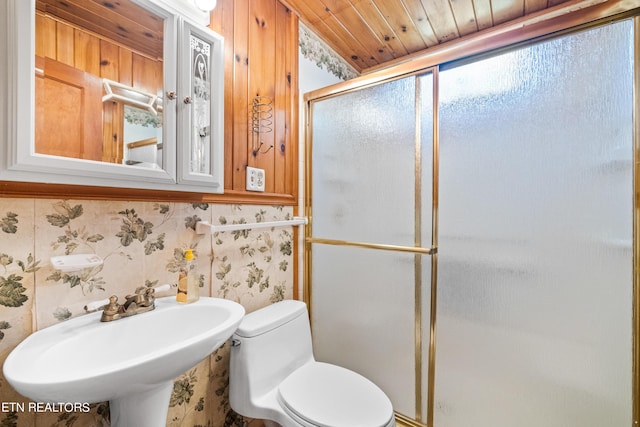 bathroom featuring toilet, walk in shower, wooden ceiling, and sink