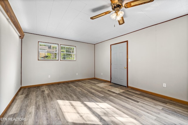 spare room featuring ceiling fan, light hardwood / wood-style flooring, and crown molding