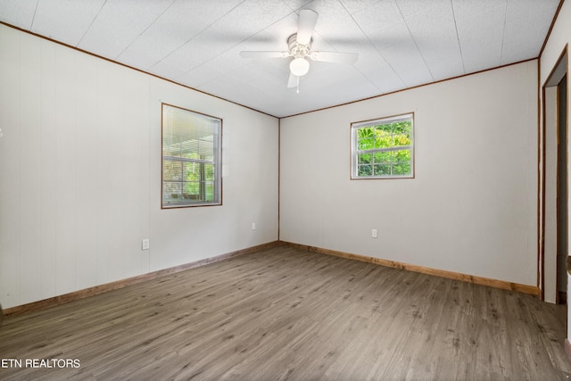 unfurnished room featuring hardwood / wood-style flooring, ceiling fan, and ornamental molding