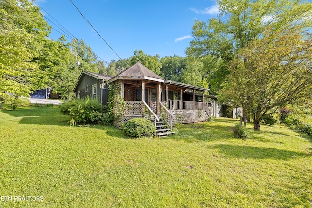 view of front of house with covered porch and a front yard