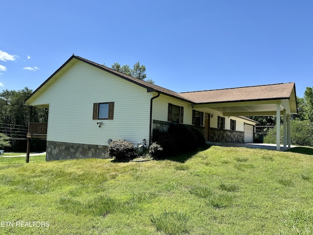 view of home's exterior with a yard and a carport