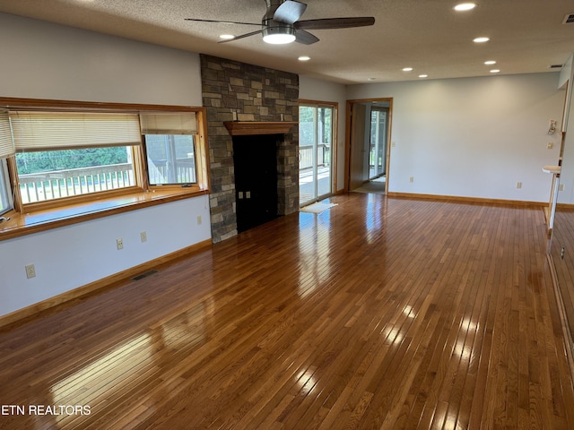 unfurnished living room with a fireplace, hardwood / wood-style flooring, and ceiling fan