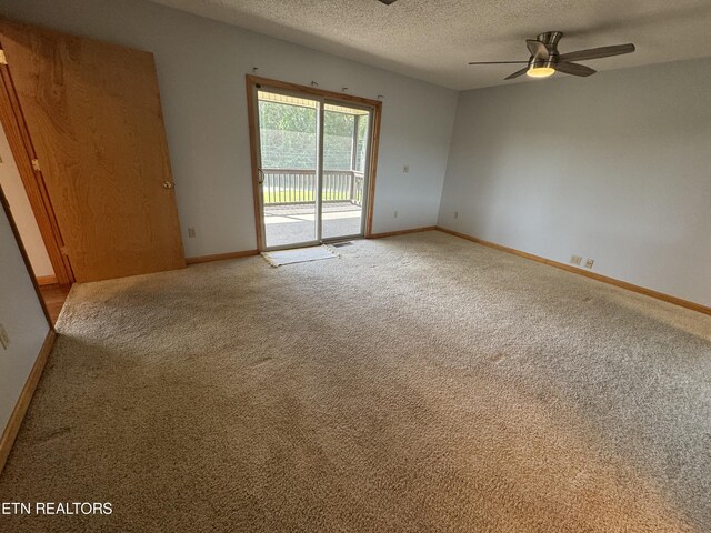 spare room with ceiling fan, carpet, and a textured ceiling