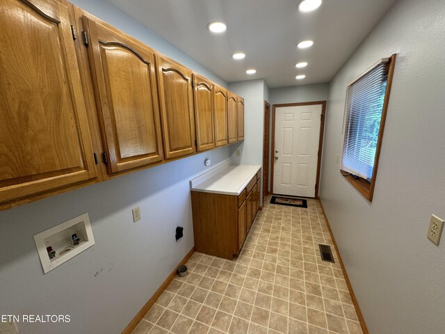 washroom featuring hookup for an electric dryer, cabinets, and hookup for a washing machine