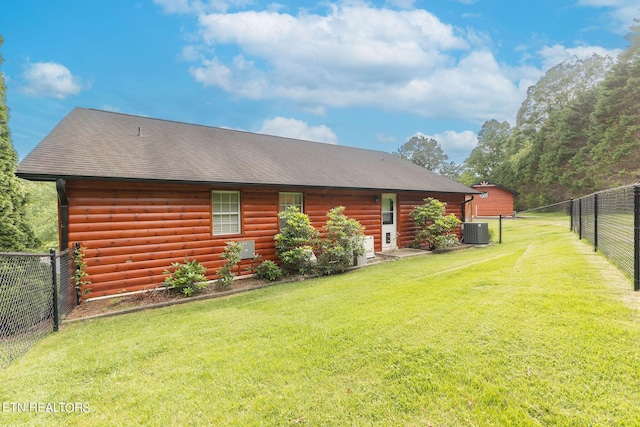 exterior space with central air condition unit and a lawn