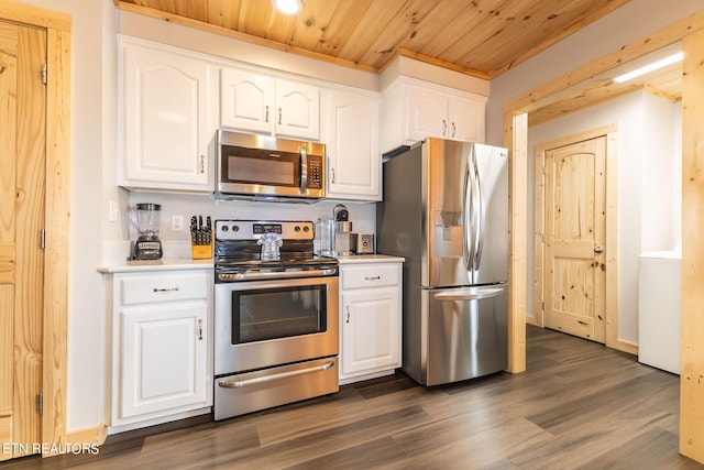 kitchen featuring appliances with stainless steel finishes, dark hardwood / wood-style flooring, wooden ceiling, white cabinets, and washer / dryer