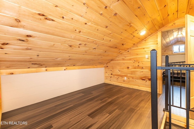 bonus room with wood walls, dark hardwood / wood-style flooring, wooden ceiling, and vaulted ceiling