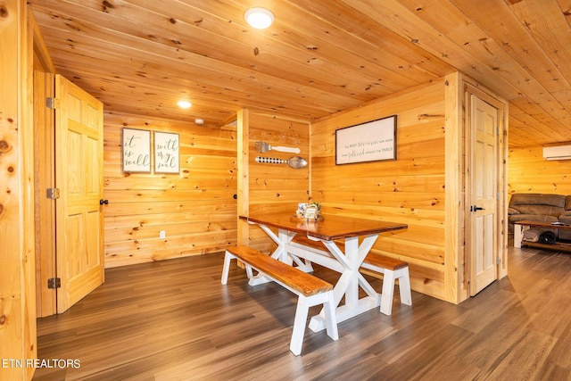 dining space featuring hardwood / wood-style flooring, wooden ceiling, and wooden walls