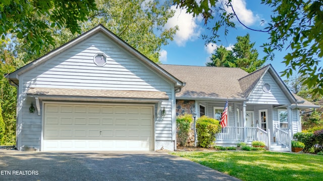 view of front of property featuring a front yard and a garage