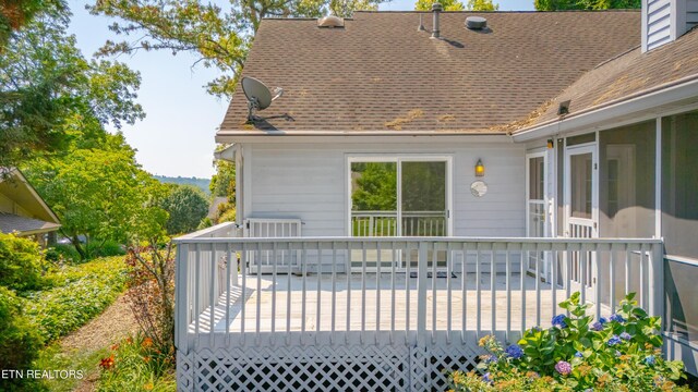 back of house with a deck