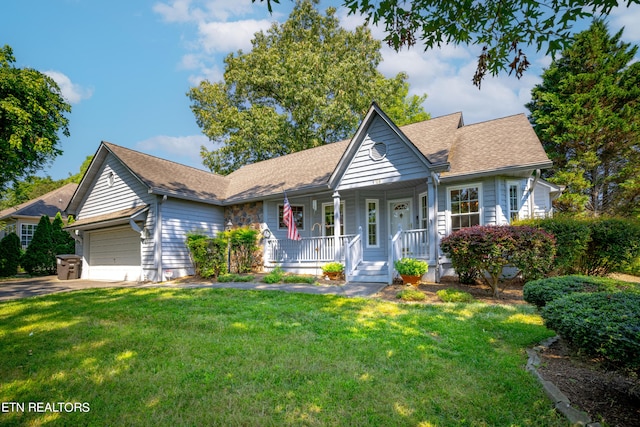 view of front facade with a front lawn, covered porch, and a garage