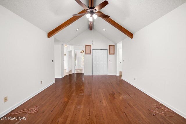 unfurnished living room with lofted ceiling with beams, ceiling fan, and dark hardwood / wood-style floors