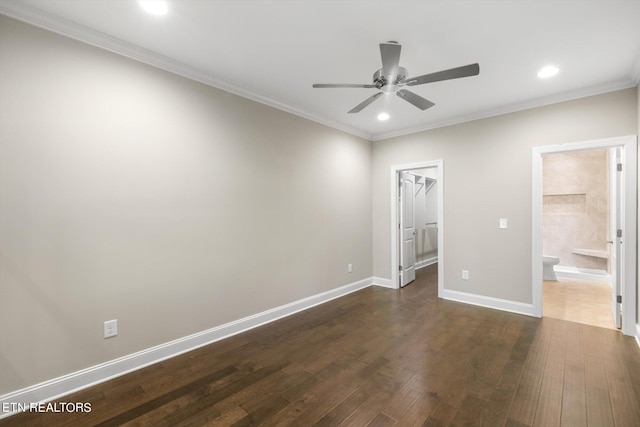 unfurnished bedroom featuring a spacious closet, a closet, ceiling fan, connected bathroom, and dark wood-type flooring