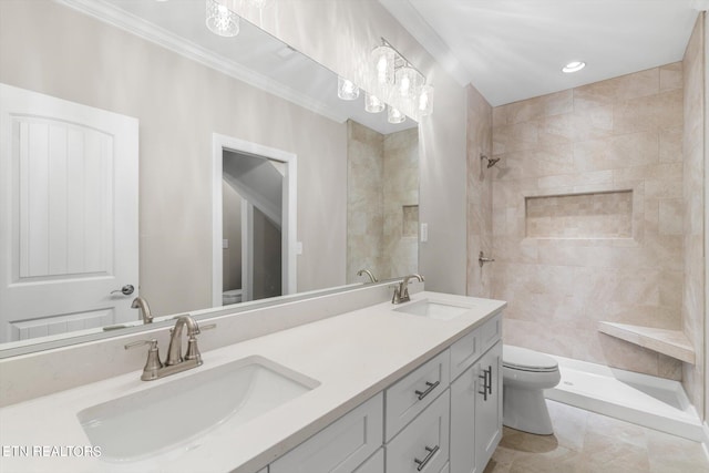 bathroom featuring toilet, tile patterned flooring, vanity, and tiled shower