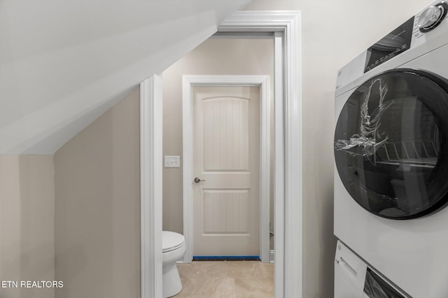 washroom featuring stacked washer and dryer