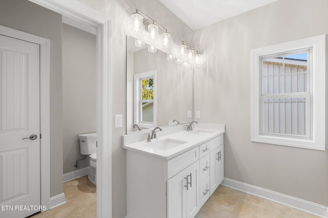 bathroom with toilet and vanity