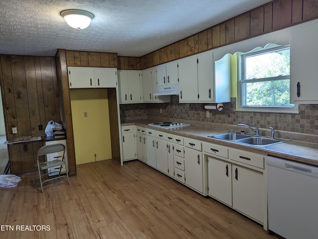 kitchen featuring light hardwood / wood-style floors, sink, white appliances, a textured ceiling, and white cabinets