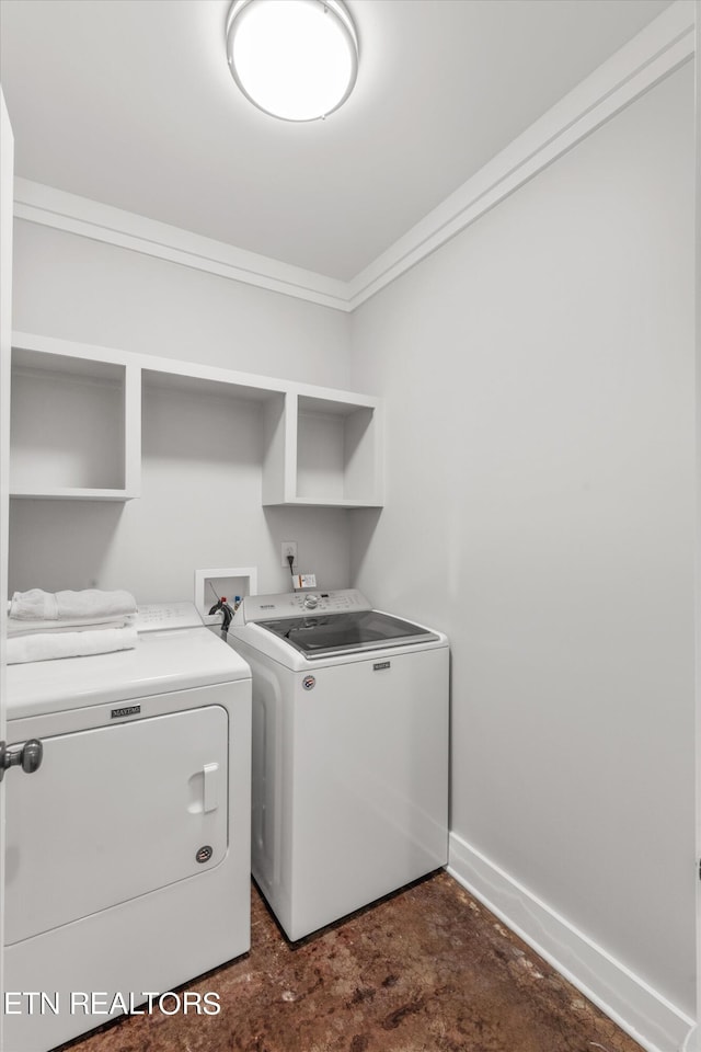 laundry room featuring washer and dryer and ornamental molding