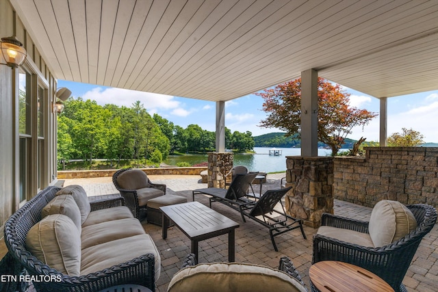 view of patio / terrace with an outdoor living space and a water view