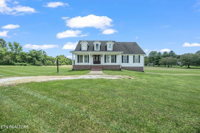 cape cod home featuring a front lawn and a porch