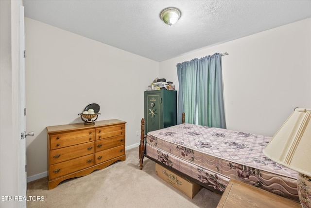 carpeted bedroom with a textured ceiling