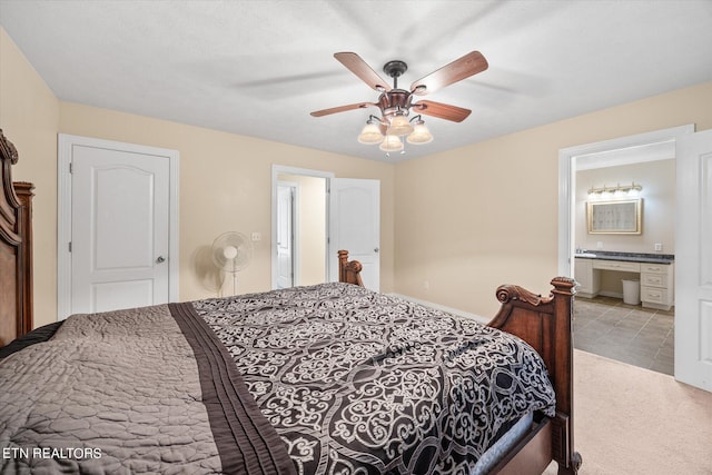 carpeted bedroom with ceiling fan and connected bathroom