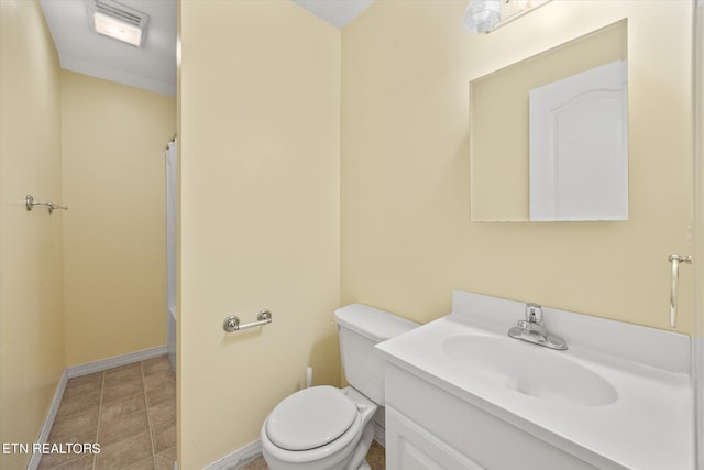 bathroom featuring toilet, vanity, and crown molding