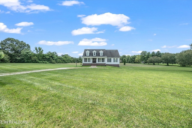 cape cod-style house featuring a front yard