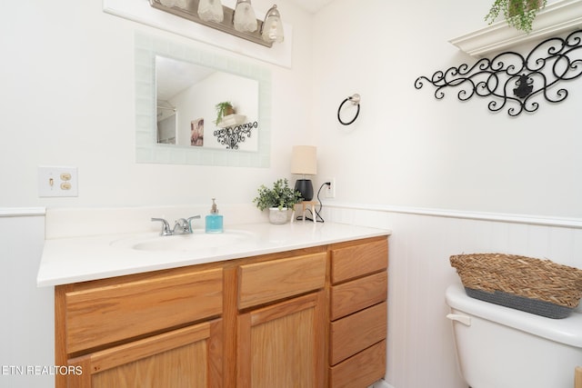 bathroom featuring toilet and vanity