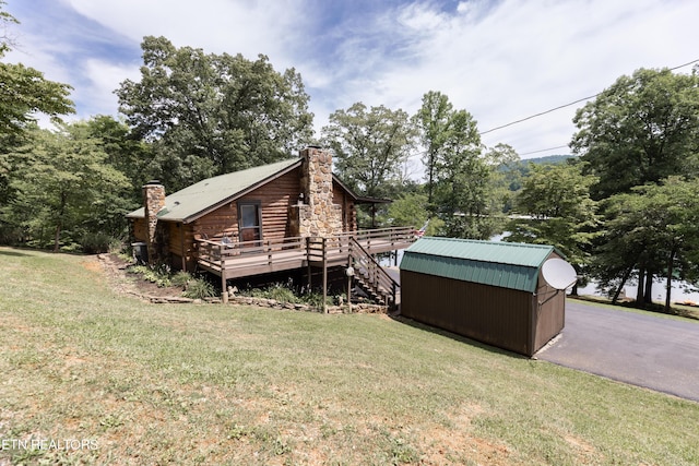 exterior space with central AC, a lawn, and a wooden deck