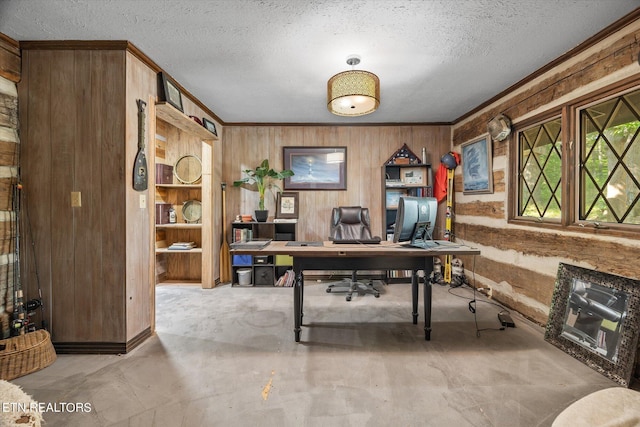 office area with a textured ceiling and wooden walls