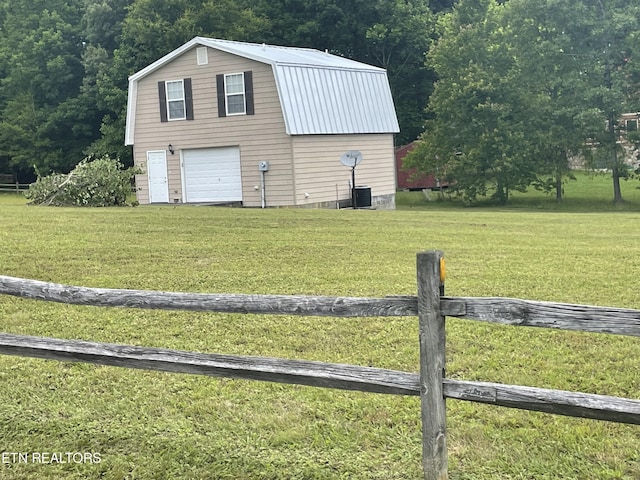 view of home's exterior featuring a lawn, cooling unit, and an outdoor structure