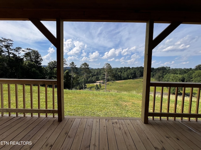 wooden deck featuring a lawn