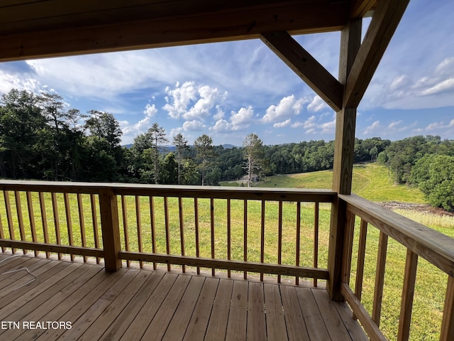 wooden terrace featuring a lawn