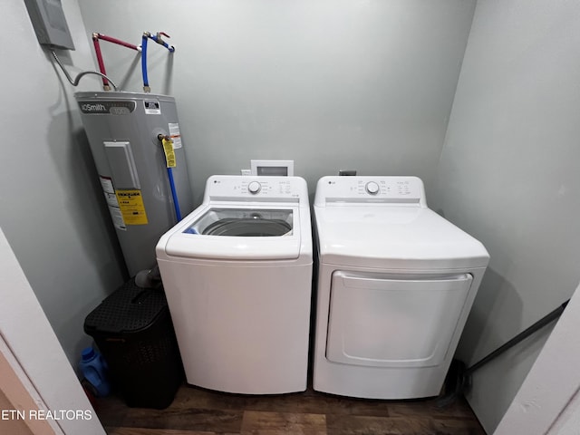 clothes washing area featuring separate washer and dryer, electric water heater, and dark hardwood / wood-style floors