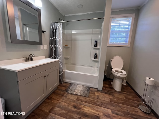 full bathroom with hardwood / wood-style flooring, a textured ceiling, vanity, and shower / tub combo