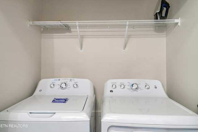 clothes washing area with washer and clothes dryer