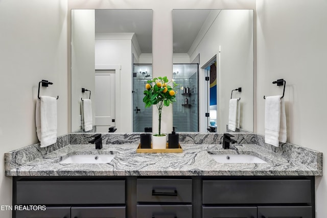 bathroom featuring a shower with door, vanity, and ornamental molding