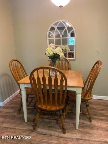 dining space with wood-type flooring