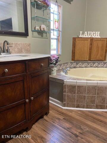 bathroom featuring vanity and hardwood / wood-style flooring